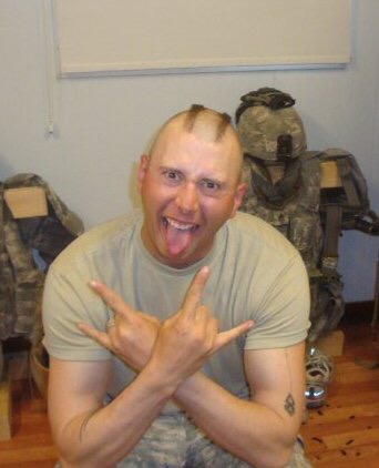 Double rock out salute with Author Tony Craidon in GI fatigues and a reverse mohawk with shaved head.
