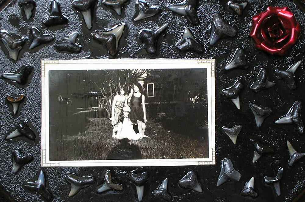 shark zombies old photograph and shark teeth collage with metal rose on wood panel