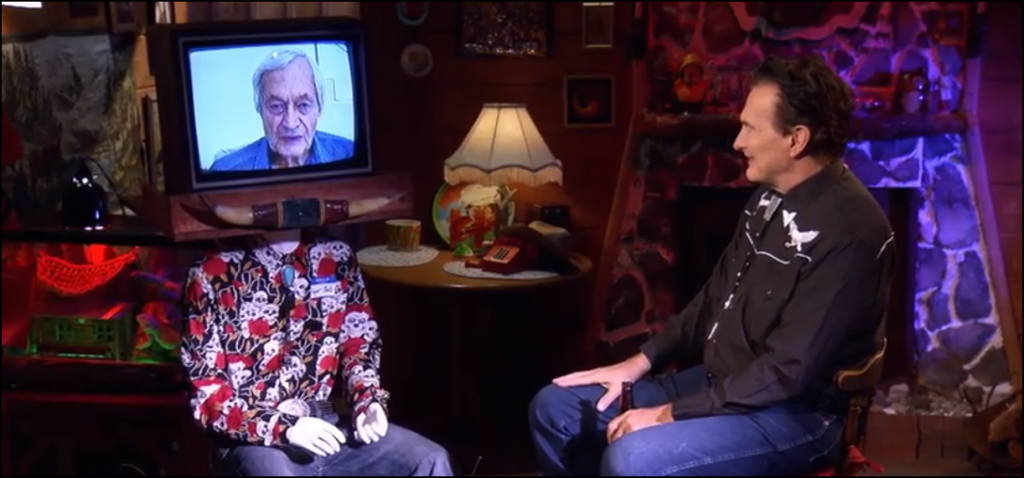 A screenshot of The Last Drive-In depicting Roger Corman being remote interviewed by Joe Bob Briggs.