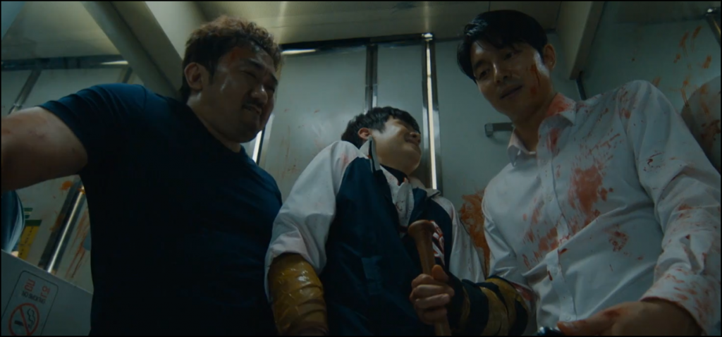 Train to Busan movie still depicting three men in a bathroom