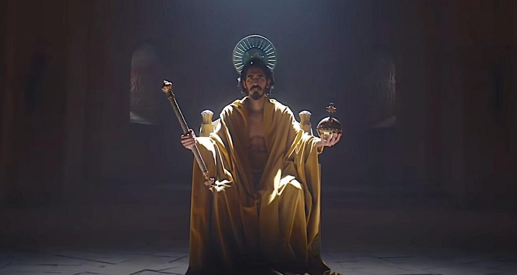 A still of Dev Patel in royal, Christ-like regalia from 2021's The Green Knight