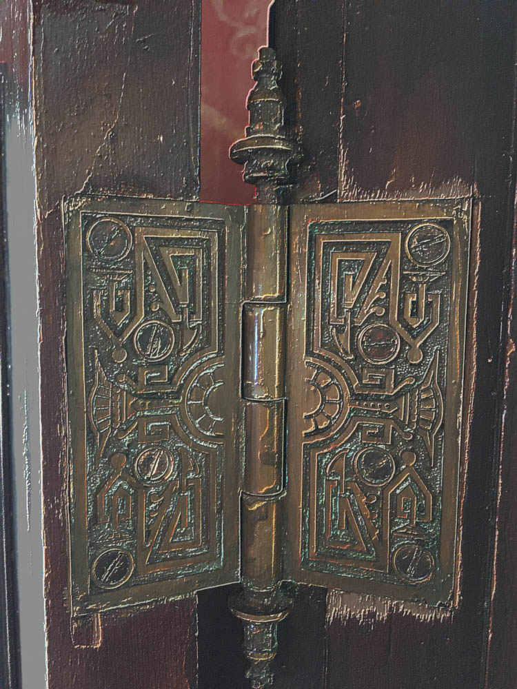 ornate carvings in brass door hinge