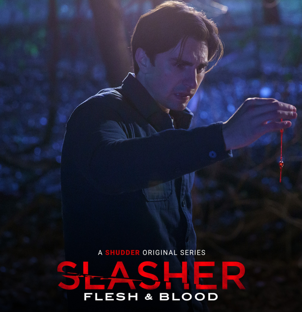 A man with neatly cut short hair stands in the woods with his hand dripping blood and guts. Slasher S4E6