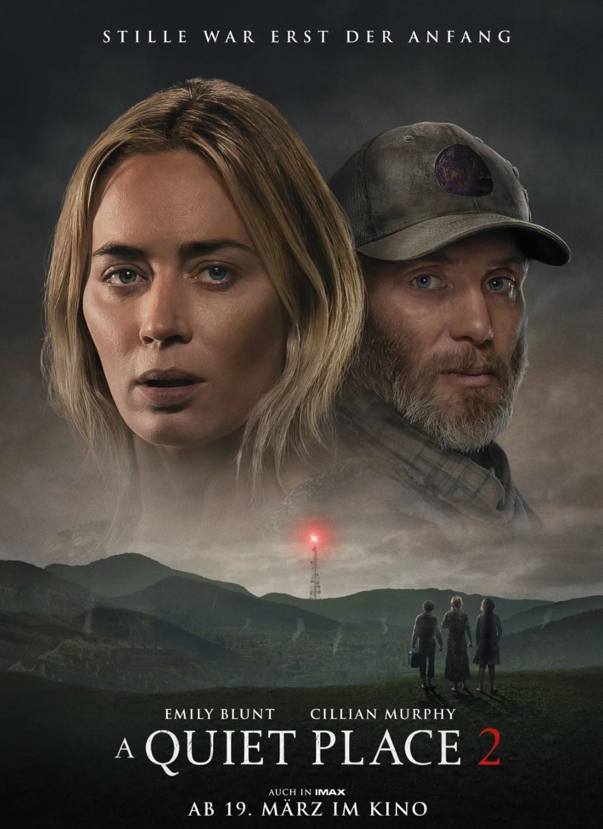 Quiet Place 2 poster with a blonde woman and a mand with a beard overlook a field