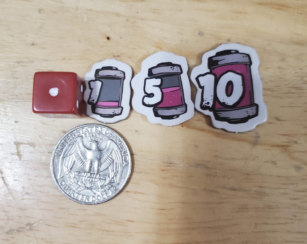 A die and each increment of jelly token are compared to the size of a quarter.