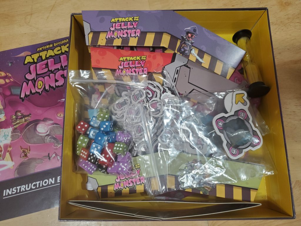 The game's components in the box, with the rulebook off to the side.