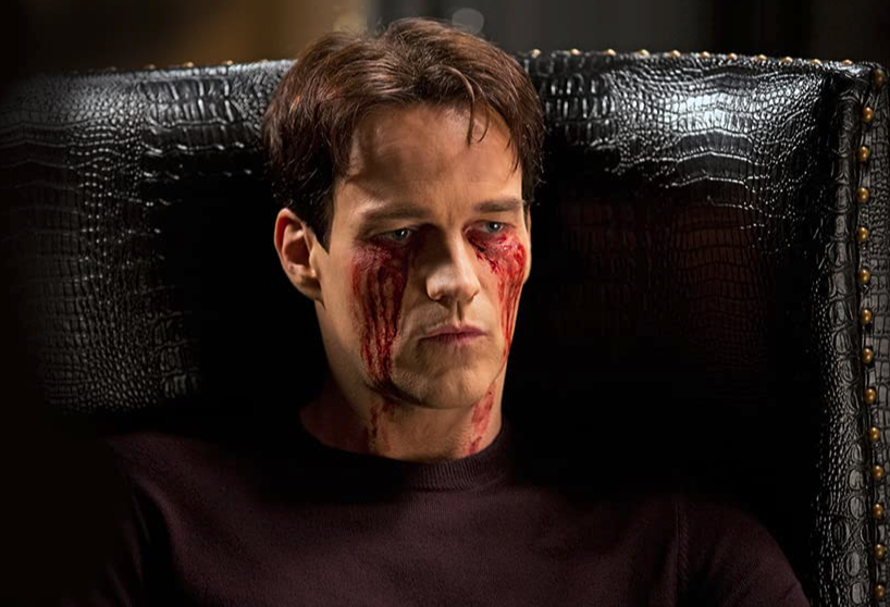 TrueBlood S6E2 Bill comatose in a chair with blood streaked on his face