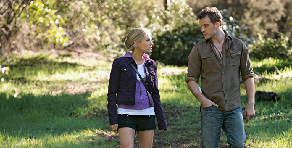 TrueBlood S6E2 Sookie and the injured man walking together in a field