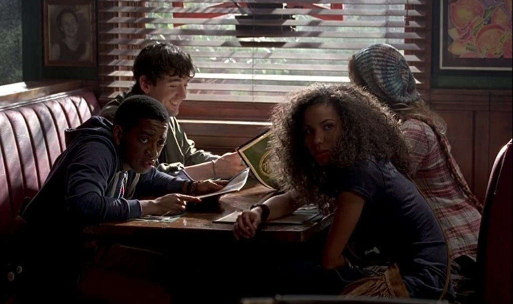 TrueBlood S6E2 A group of activists sit at a table at Merlotte's