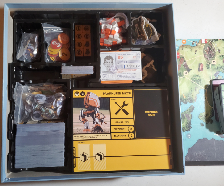 Tales From the Loop components in the box. Character boards were removed to show the compartments underneath. The minis go under the big machine cards.