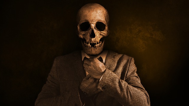 Man in a suit with a skull for a face