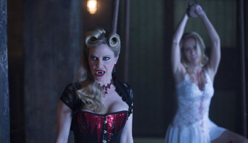 TrueBloodS7E10 Pam in the foreground with Sarah chained up in the background