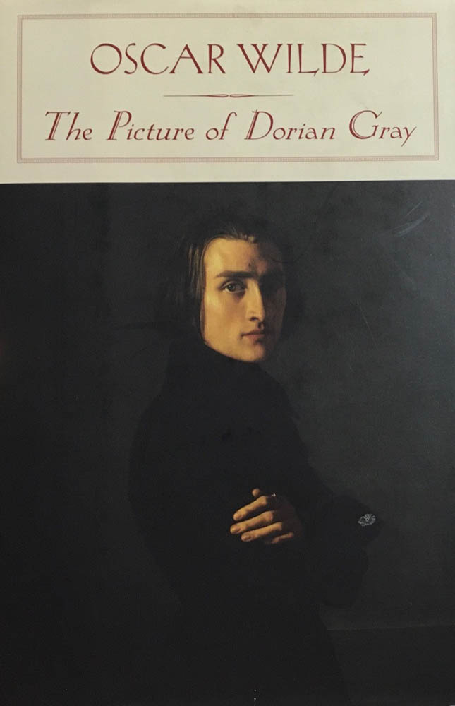 Oscar Wilde, The Picture of Dorian Gray front cover with portrait of a young man with piercing eyes on black background