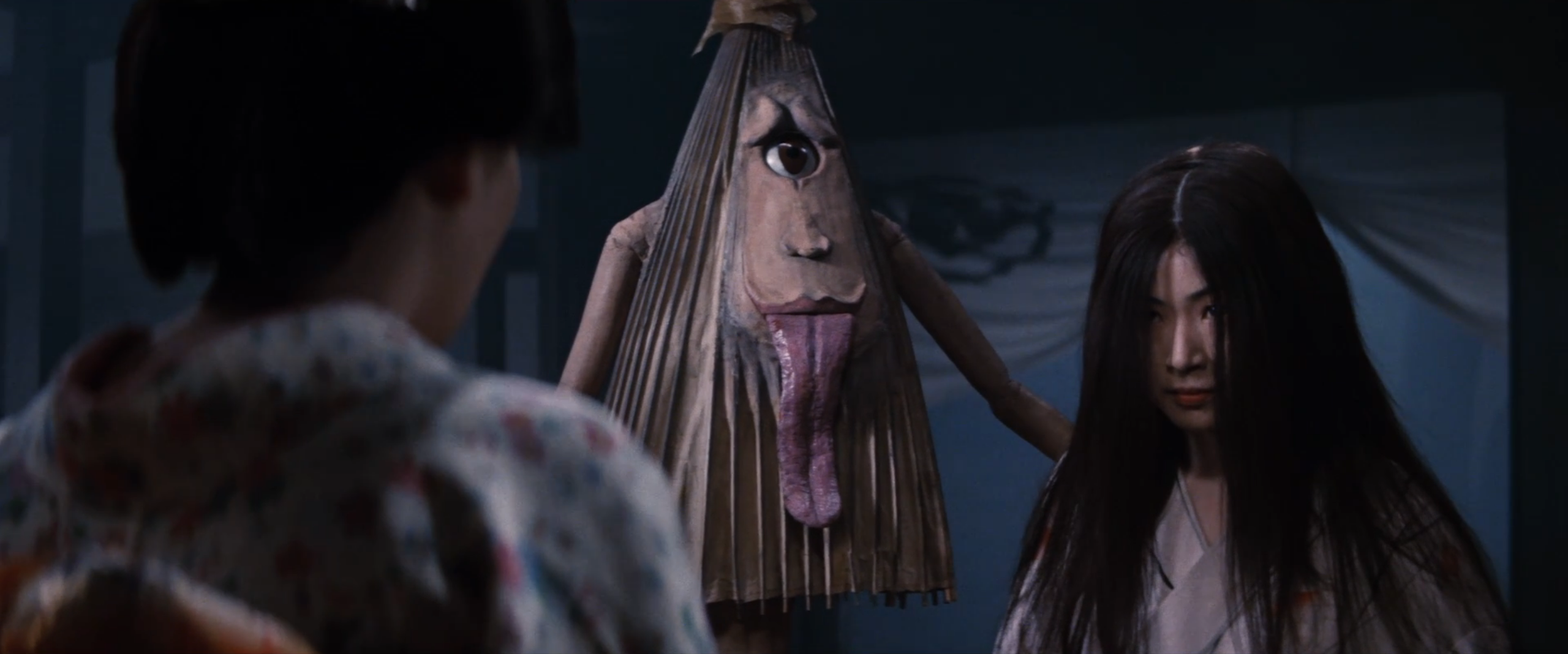 A cyclops umbrella monster, kasa-obake, appears beside a young woman's spirit in Spook Warfare