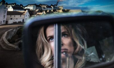 Marionette Cover Art: Woman looking through a rearview mirror in a small town