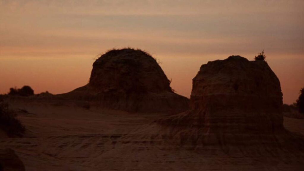 Scenic Desert view as the sun sets over two mounds