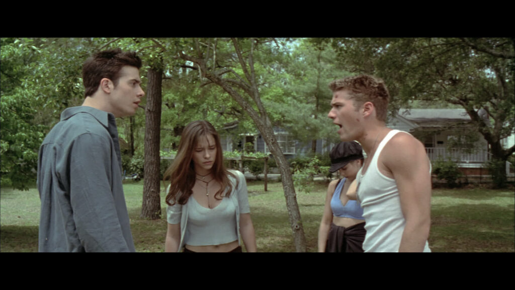 Four people stand around in a circle, mid argument. Left to right - Ray, Julie, Helen and Barry.