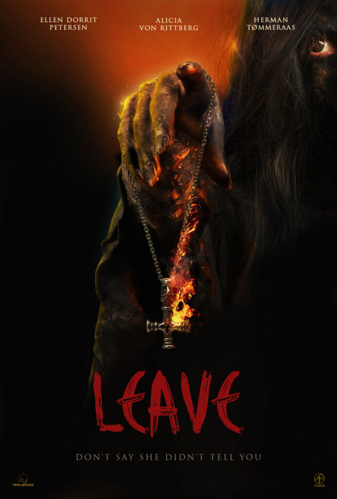 official film poster for Leave. We see a hooded individual holding a silver inverted cross necklace engulfed in bright orange and yellow flames. The individual holding the flaming cross has yellows hands and long rotted finger nails. one eye peers from thick-long black hair. The title Leave is smeared along the bottom in bright blood. 