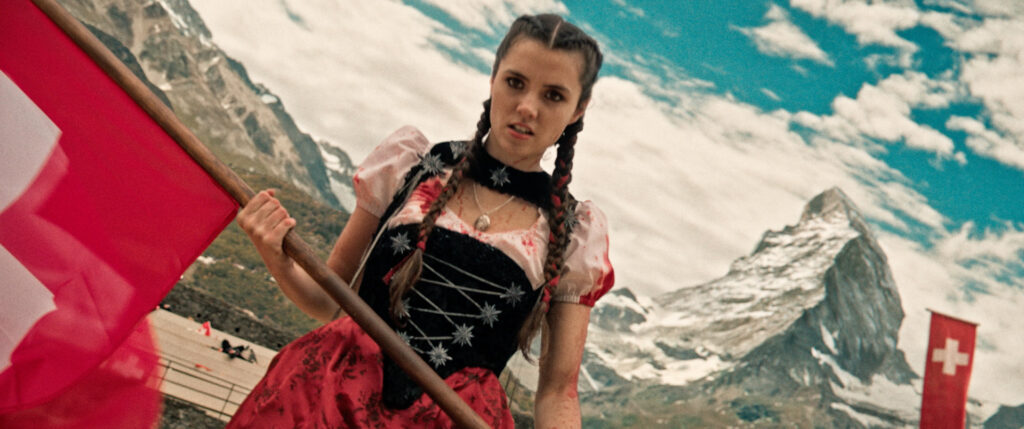 Mad Heidi with blood all over her and the alps in the background.