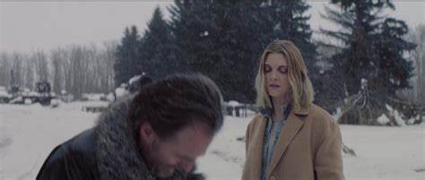 Vaughn flinching away from Grey as she glares at him. The surrounding is a snowy forest.