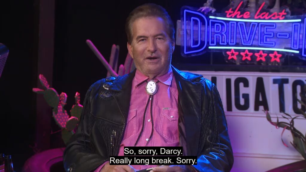 A photo of Joe Bob apologizing to Darcy for talking so much. He is saying "So, sorry, Darcy. Really long break. Sorry!"