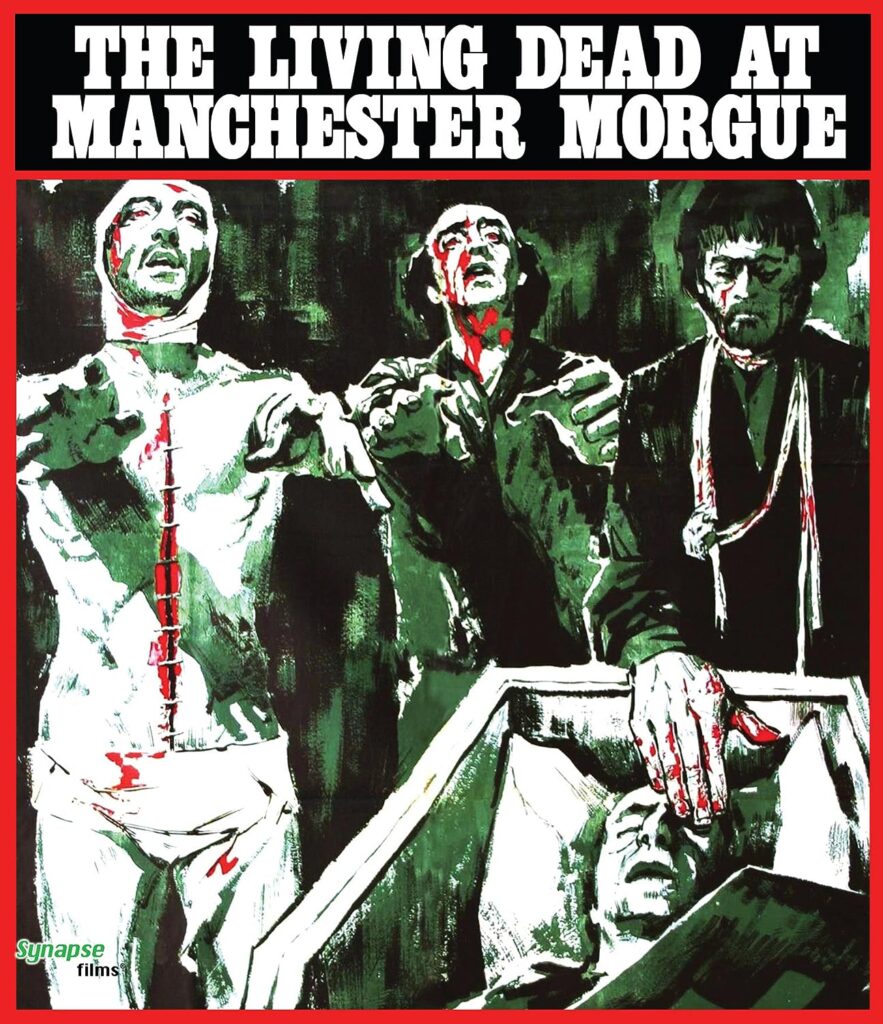 A poster for The Living Dead at Manchester Morgue. It shows two zombies with their arms outstretched. They are next to a man who is placing is bloodstained hands over the eye of a man in a coffin.