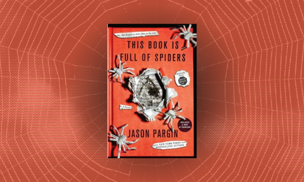Spider webs behind the cover of a book with paper spiders spilling out of the front with the words This Book is Full of Spiders