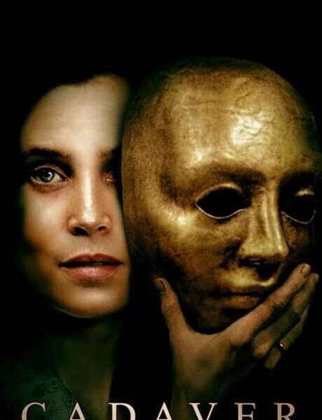 A woman removing her golden mask atop a black background. Below her reads "Cadaver."