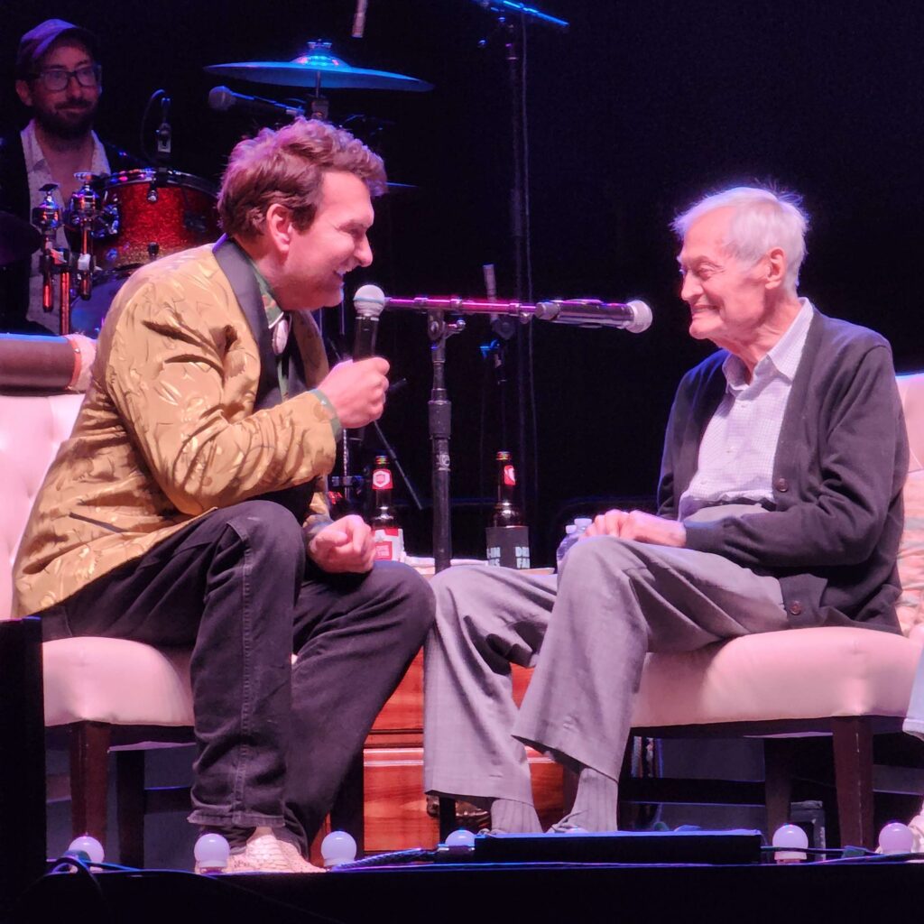 A photo of Joe Bob interviewing Roger Corman on stage at the Jamboree.