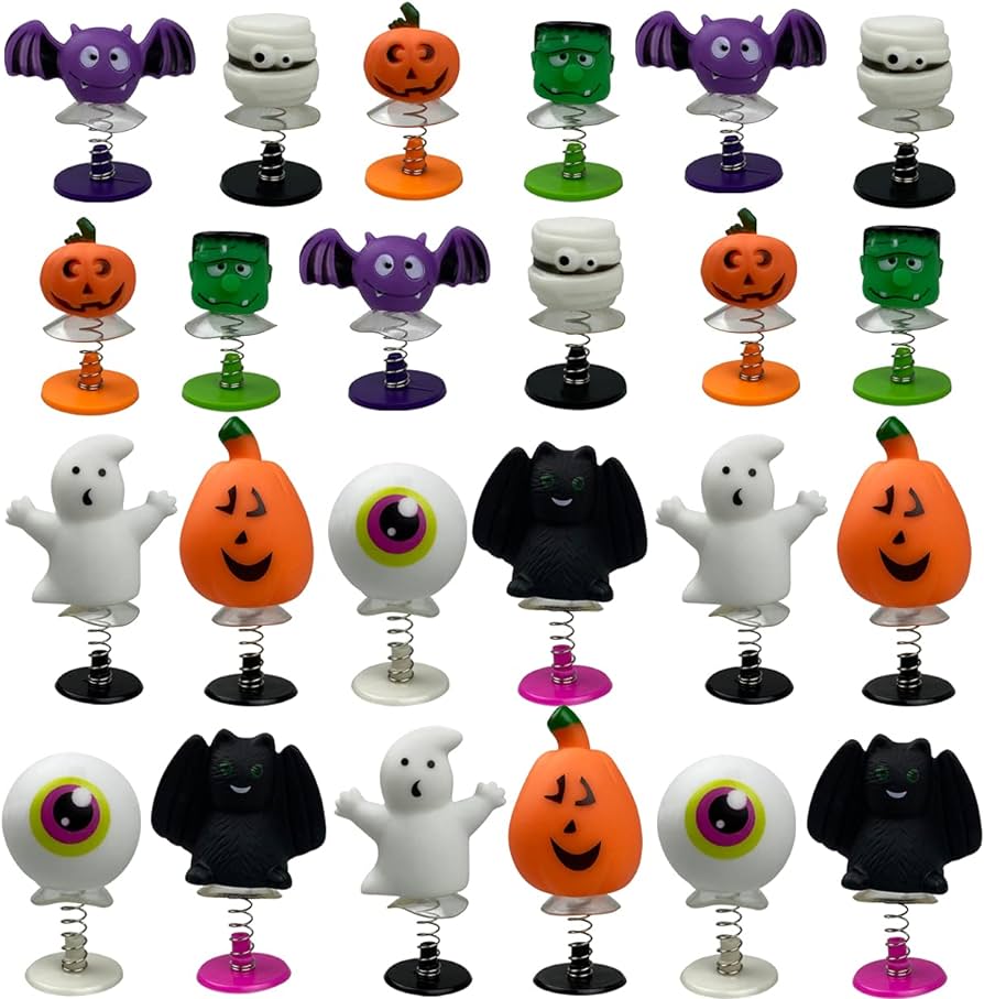 A photo of Halloween popper toys. The are small figures on a spring with a suction cup. There are bats, mummies, pumpkins, ghosts, and frankenstein heads.