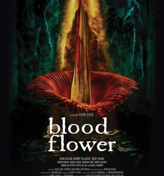 A flower opens up in a dark background. Underneath the white text reads "blood flower".