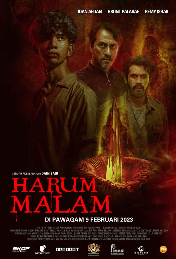 A young man stands before two older men. A giant flower in bloom to his left side. Underneath him reads "Harum Malam" written in red.