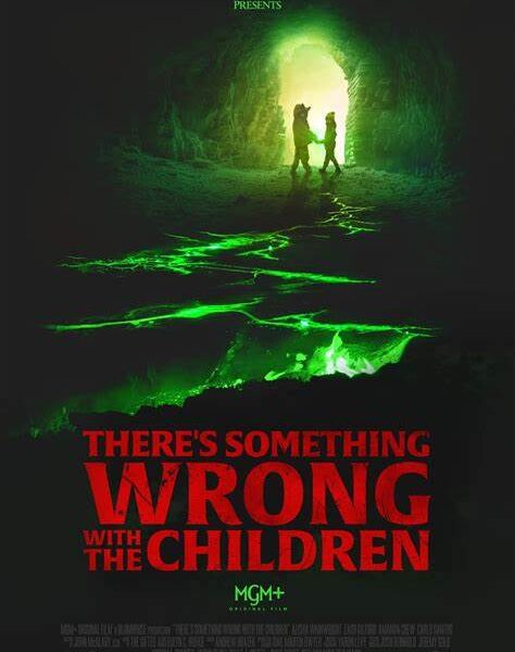 A green light reveals two children holding hands. A green stream lights up an otherwise dark surrounding. The title reads "There's Something Wrong with the Children" in red.