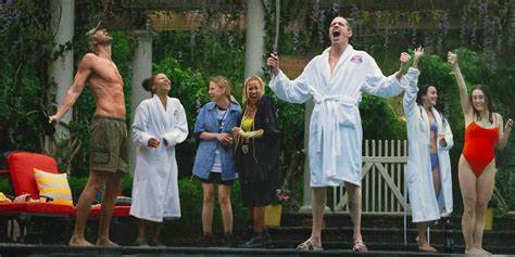 A group of friends screaming outside. They all are dressed in swim suits or robes.