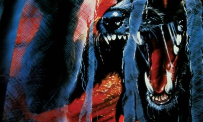 A long snouted creature rips through a white screen. The title "Howling III" written in red underneath.