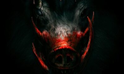 A creature with large tusks emerges from a darkness. Above its head reads Boar.