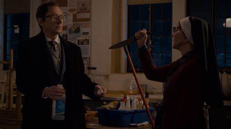 A man holds out a jar and a nun holds out a knife