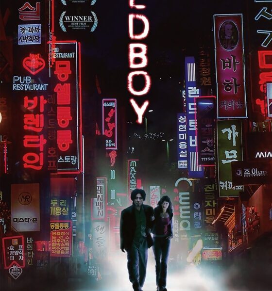 Among colorful neon signs light up both sides of the poster. Between reads Oldboy, written vertically. A man and woman walk underneath it all, looking lost and small.