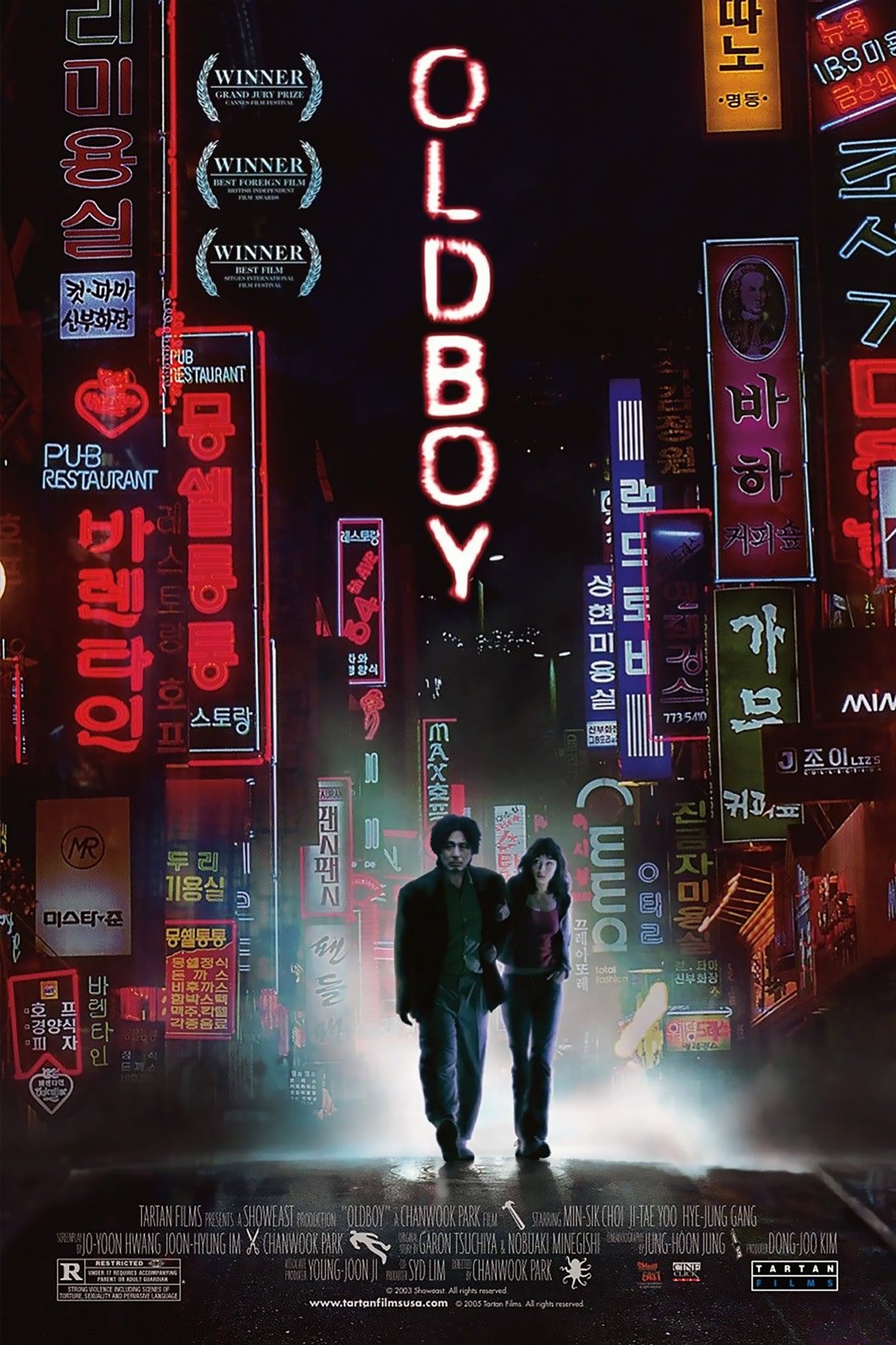 Among colorful neon signs light up both sides of the poster. Between reads Oldboy, written vertically. A man and woman walk underneath it all, looking lost and small.