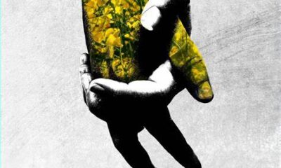 A shadowed hand and a hand made of yellow flowers hold onto each other. Below reads Violett in red.