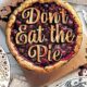 Don't Eat The Pie cover. Picture of a pie with red filling with title in pastry on the top.