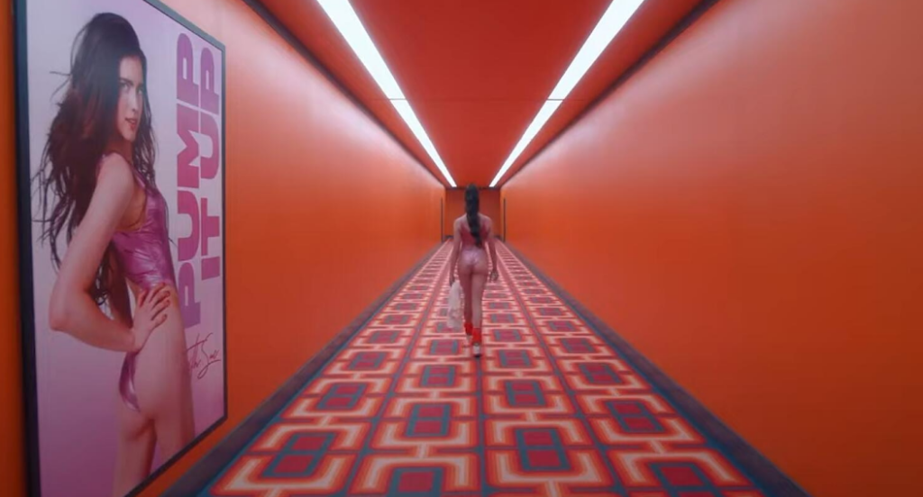 Sue walking down a hall that looks like something out of The Shining