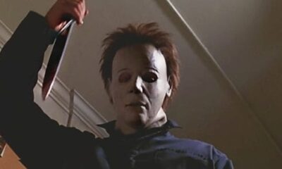 Michael Myers has a kitchen knife raised staring at something off-screen.