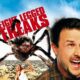 David Arquette is looking above mid yelling about something as a giant spider is behind him. EIGHT LEGGED FREAKS is in large red letters in the background of a blue sky.